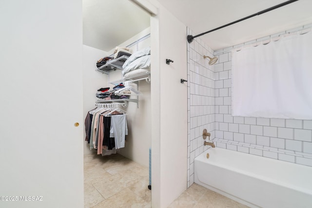 bathroom with tile patterned floors and tiled shower / bath combo