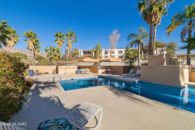 view of swimming pool featuring a mountain view and a patio area