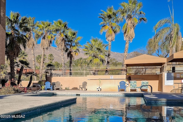 view of swimming pool featuring a mountain view and a patio