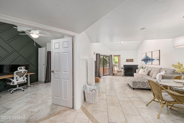 living room featuring ceiling fan and vaulted ceiling