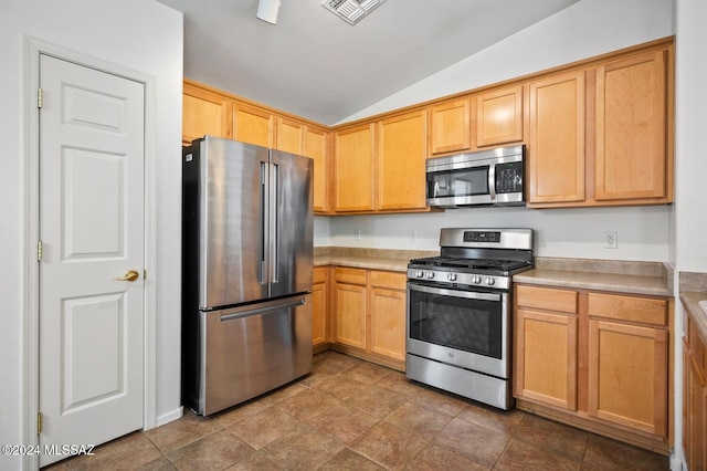 kitchen with lofted ceiling and appliances with stainless steel finishes