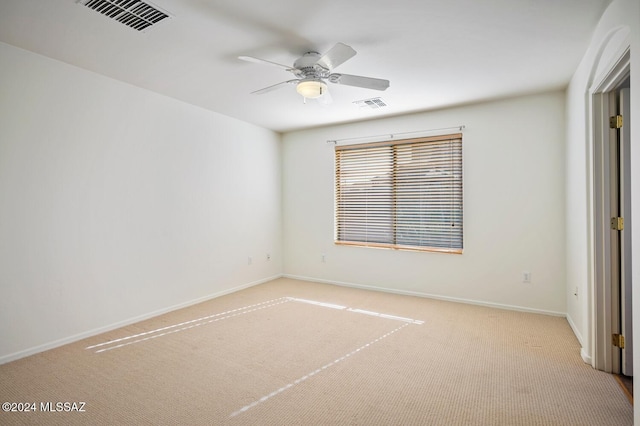 carpeted spare room with ceiling fan