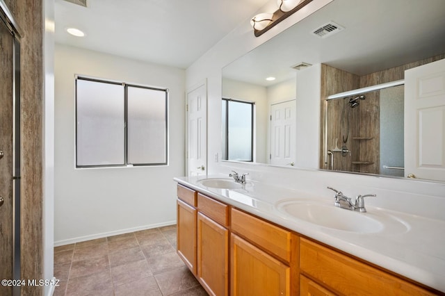 bathroom featuring vanity, an enclosed shower, and tile patterned floors