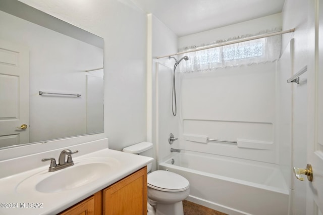 full bathroom featuring washtub / shower combination, vanity, and toilet