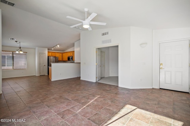 unfurnished living room with ceiling fan and lofted ceiling