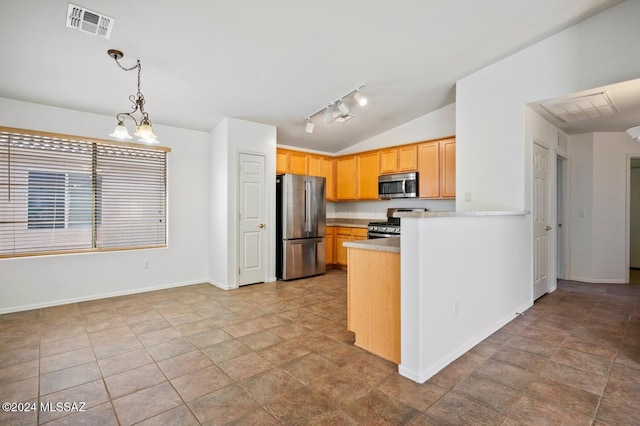 kitchen featuring lofted ceiling, rail lighting, hanging light fixtures, light brown cabinets, and appliances with stainless steel finishes