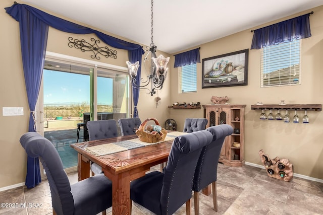 dining space with an inviting chandelier