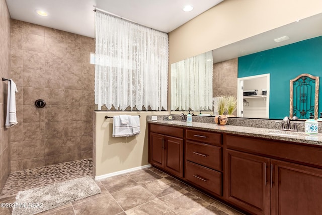 bathroom featuring vanity and a tile shower