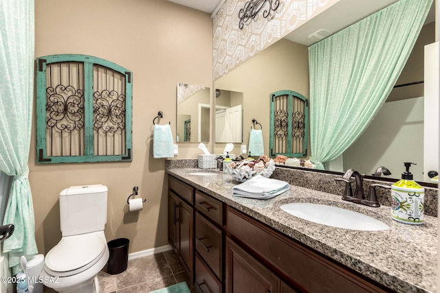 bathroom with vanity, tile patterned flooring, and toilet