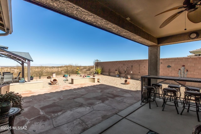 view of patio / terrace with an outdoor bar and ceiling fan