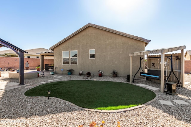 rear view of house featuring a yard and a patio area