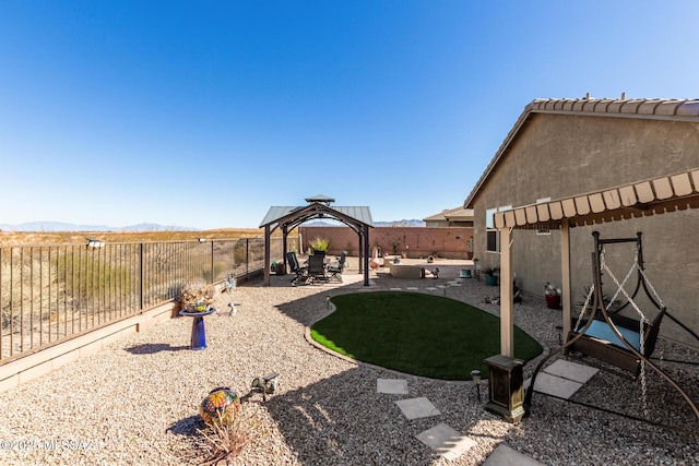 view of yard with a mountain view, a gazebo, and a patio