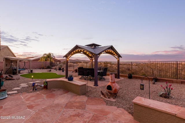 view of patio terrace at dusk