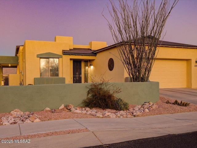 southwest-style home featuring a garage