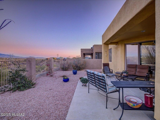 patio terrace at dusk with an outdoor hangout area