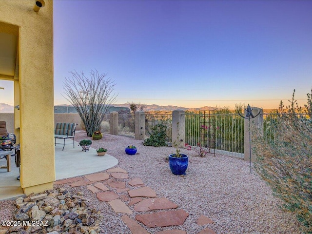 view of patio terrace at dusk