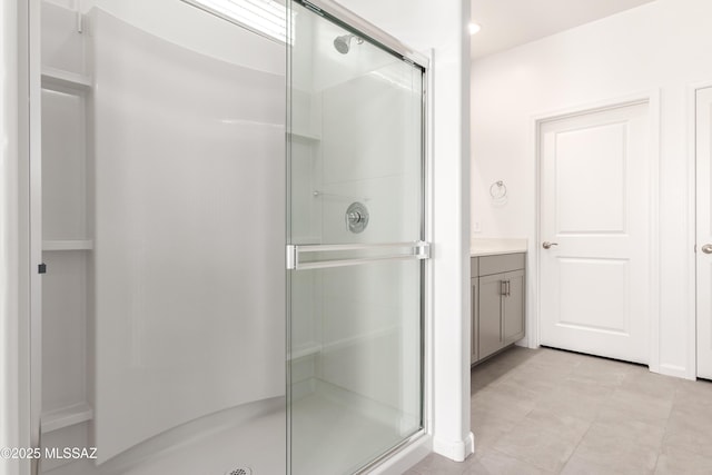 bathroom featuring vanity and a shower with door