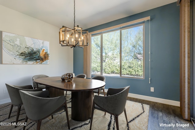 dining room with a notable chandelier, plenty of natural light, and dark wood-type flooring