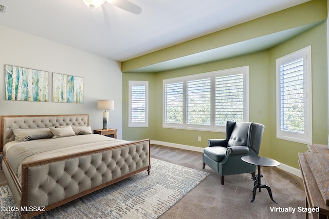 carpeted bedroom with multiple windows and ceiling fan