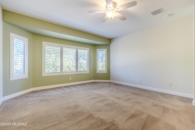 carpeted spare room with ceiling fan