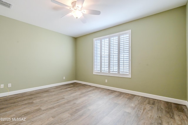 unfurnished room with light wood-type flooring and ceiling fan