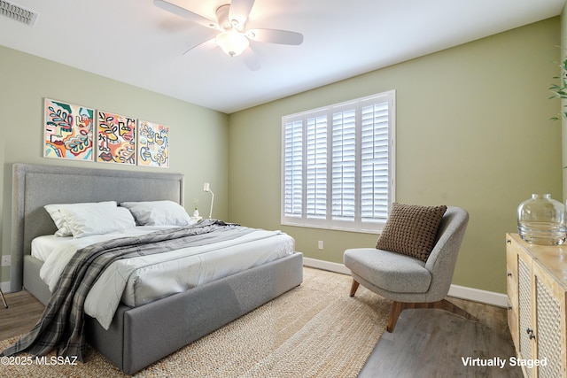 bedroom with ceiling fan and hardwood / wood-style flooring