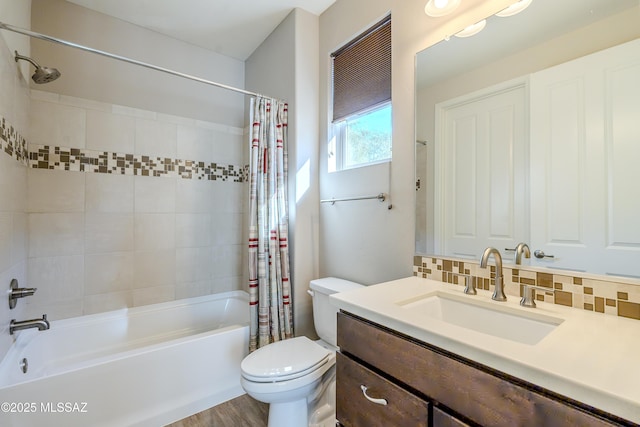 full bathroom featuring toilet, hardwood / wood-style floors, tasteful backsplash, shower / bath combo, and vanity