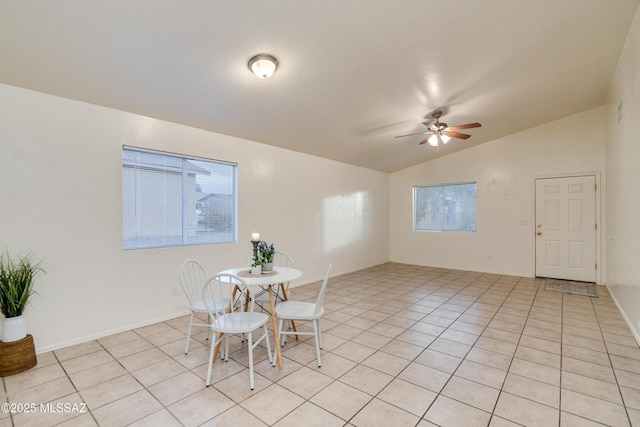 tiled dining room featuring vaulted ceiling and ceiling fan