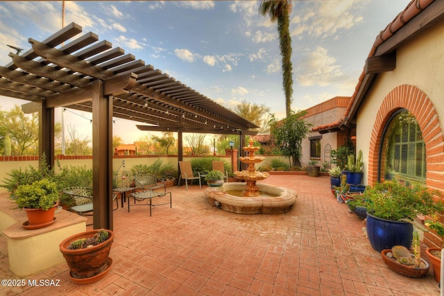 patio terrace at dusk featuring a pergola