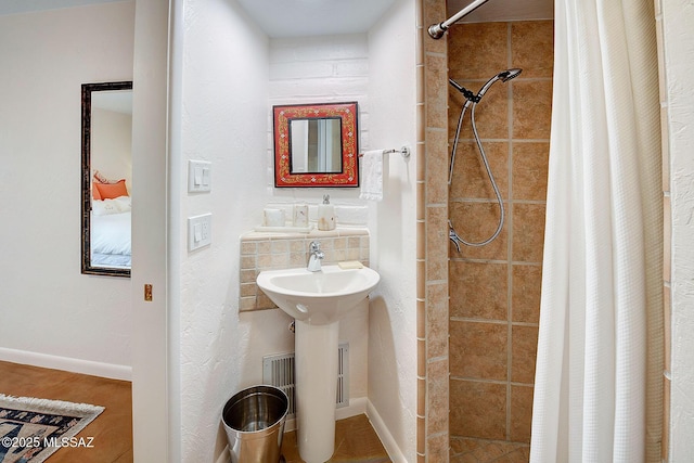 bathroom with sink and curtained shower