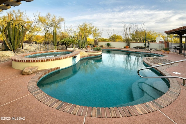 view of swimming pool featuring an in ground hot tub and a patio