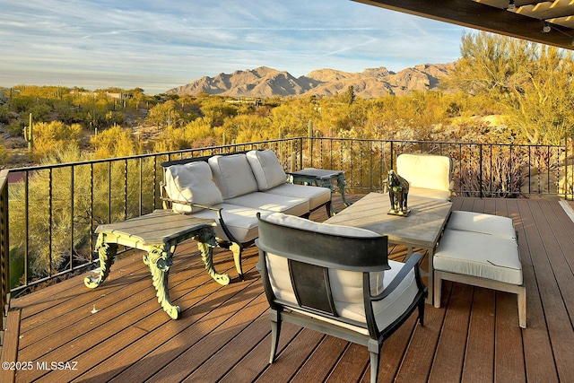 wooden deck with an outdoor living space and a mountain view