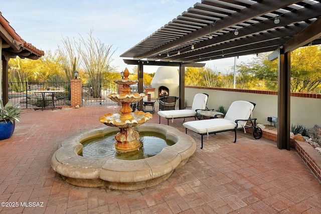 view of patio / terrace with a pergola and an outdoor fireplace