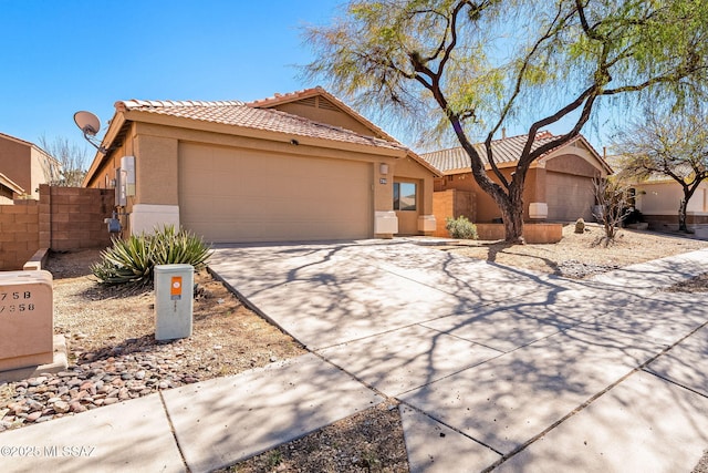 view of front of property with a garage, driveway, a tiled roof, and stucco siding