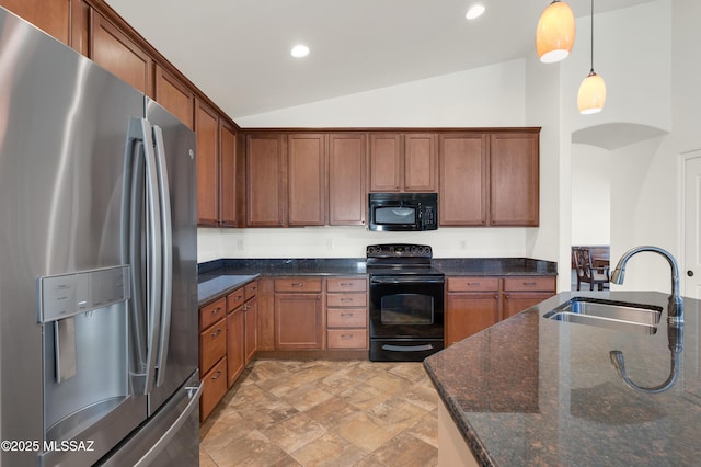 kitchen featuring lofted ceiling, sink, dark stone countertops, black appliances, and decorative light fixtures