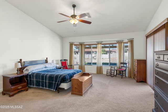 bedroom featuring vaulted ceiling, light colored carpet, and ceiling fan