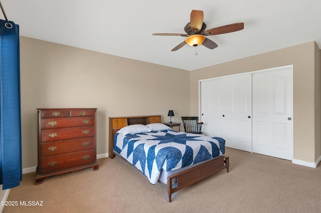 bedroom with ceiling fan, a closet, and light carpet