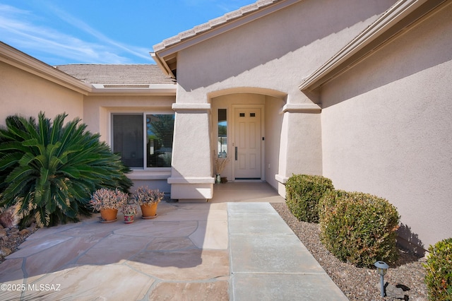 property entrance featuring a patio area