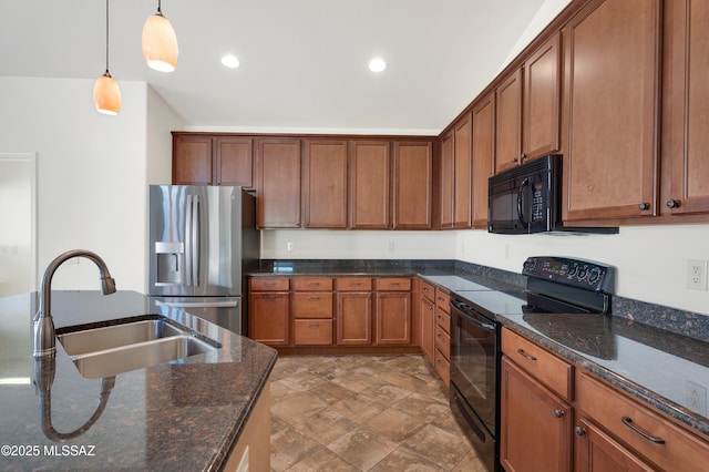 kitchen with decorative light fixtures, sink, dark stone countertops, and black appliances