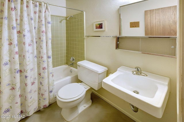 bathroom featuring a sink, toilet, and shower / tub combo