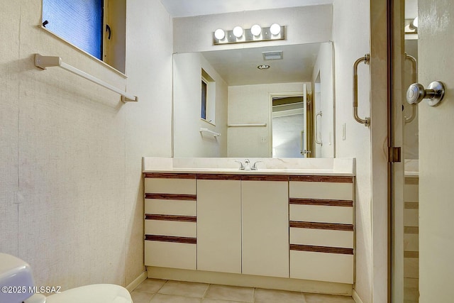 bathroom with tile patterned flooring, visible vents, toilet, and vanity