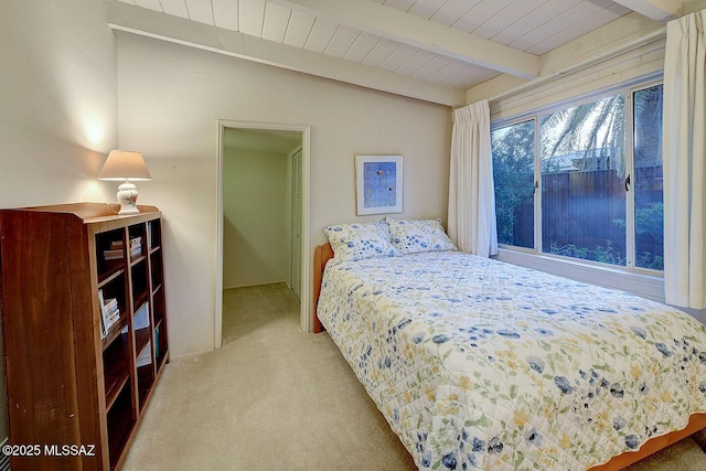 bedroom with carpet and beamed ceiling