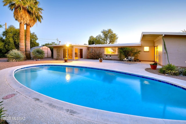 outdoor pool with a patio area