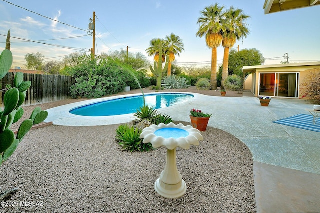 view of swimming pool with a fenced in pool, a fenced backyard, and a patio area