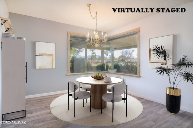 dining space featuring hardwood / wood-style flooring and a chandelier