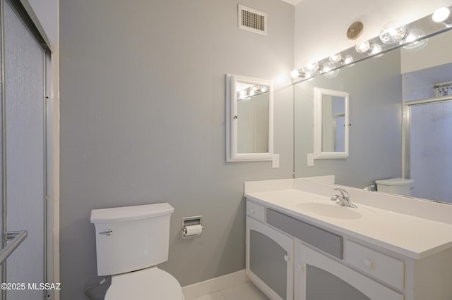 bathroom with vanity, walk in shower, and toilet