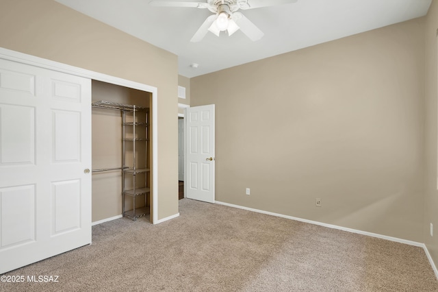 unfurnished bedroom featuring carpet flooring, ceiling fan, and a closet