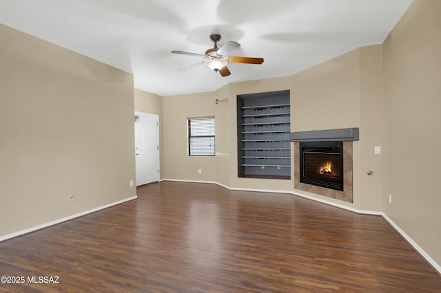 unfurnished living room with dark hardwood / wood-style floors and ceiling fan