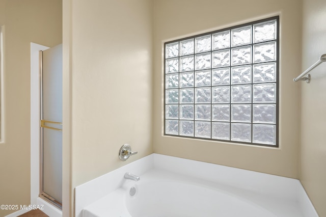 bathroom featuring plus walk in shower and a wealth of natural light