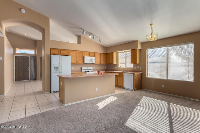 kitchen featuring decorative light fixtures, white appliances, light colored carpet, a chandelier, and a center island